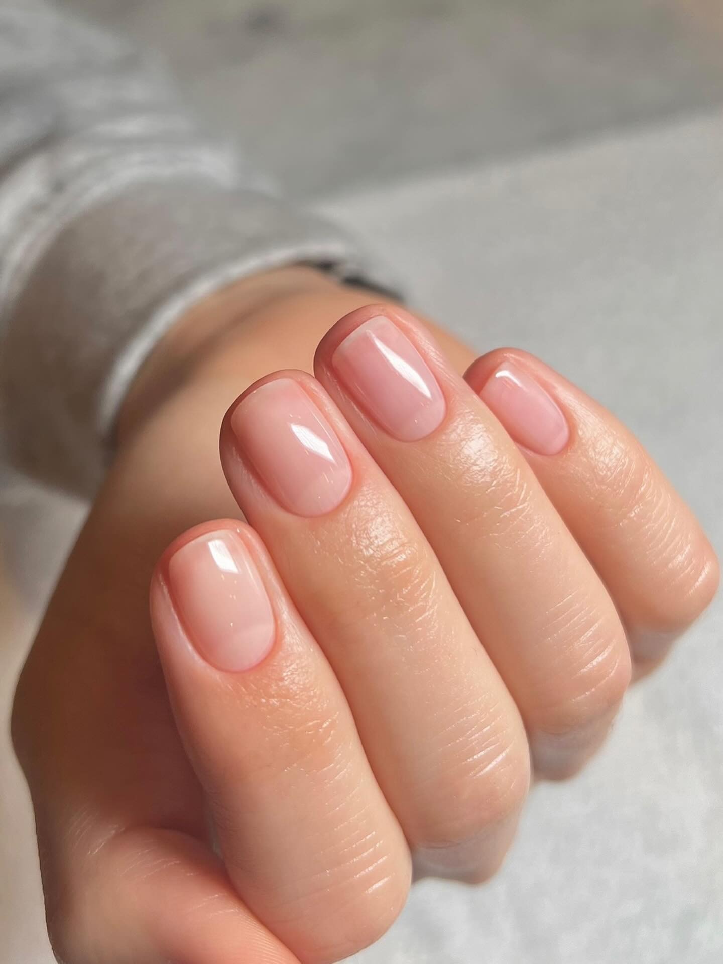 A short, clear, barely there manicure