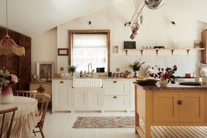 White and yellow kitchen designed by deVOL