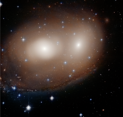 Hubble's snapshot of an early-stage collision between two galaxies looks remarkably like a giant jack-o-lantern in the sky.