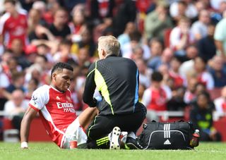 Jurrien Timber of Arsenal receives medical treatment during the Premier League match between Arsenal FC and Nottingham Forest at Emirates Stadium on August 12, 2023 in London, England.