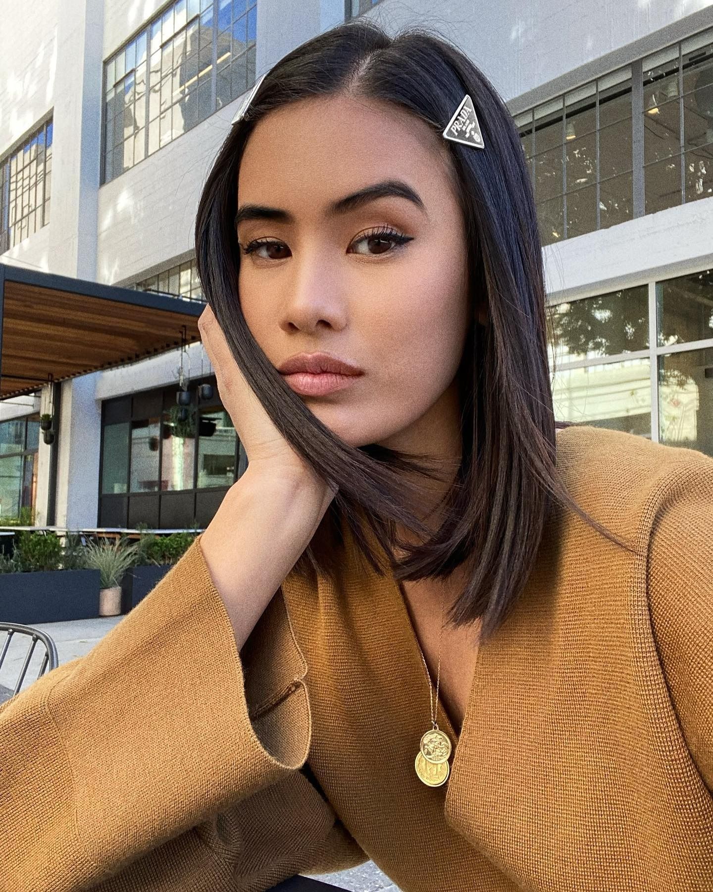 Creator @littleblackboots taking a selfie with smooth, frizz-free hair