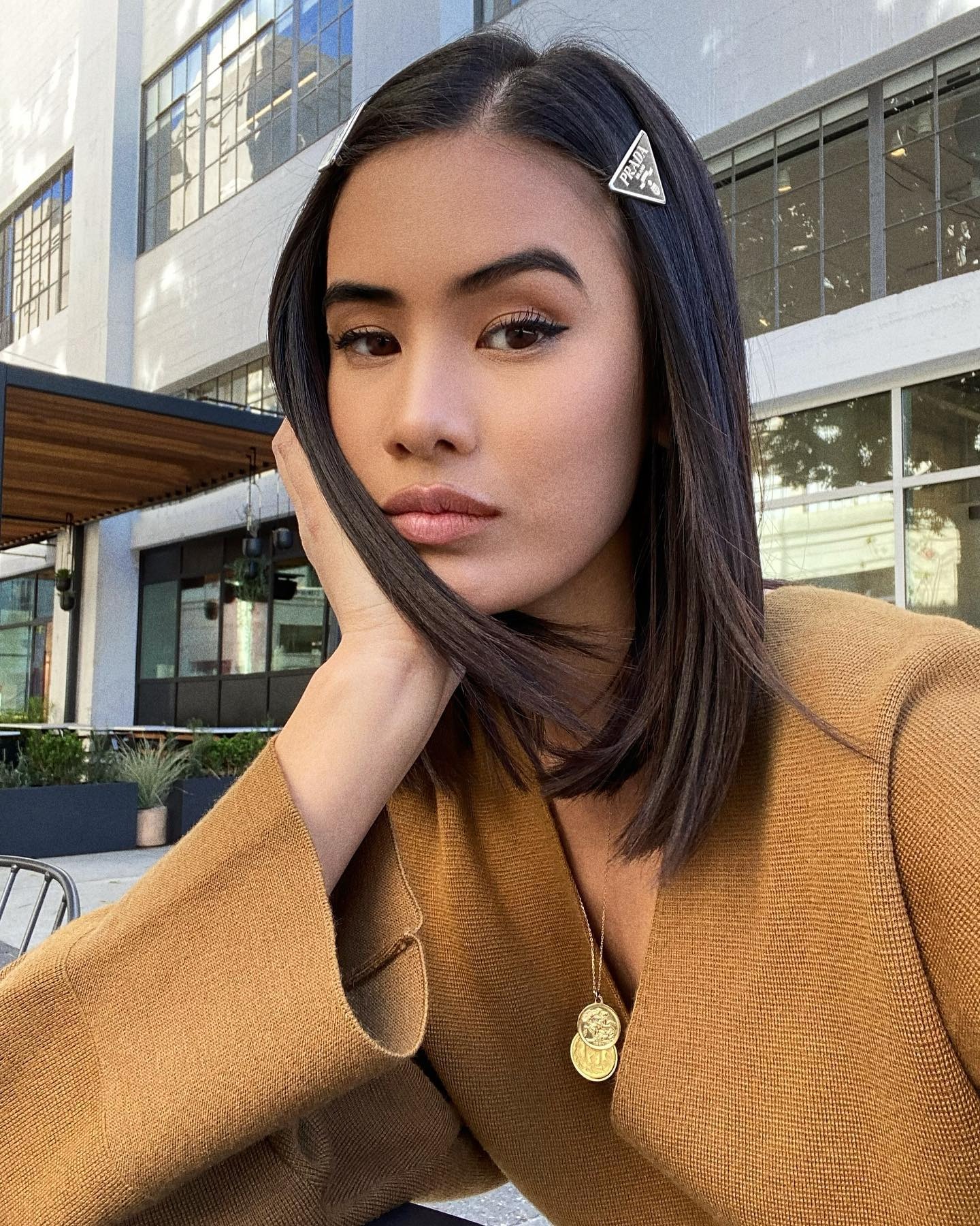 Creator @littleblackboots taking a selfie with smooth, frizz-free hair.