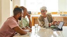 A financial adviser meets with clients in a conference room.