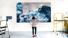 Zaria Forman in her studio looking at Whale Bay no. 4, a drawing now on display at the Harvard University Center for the Environment.