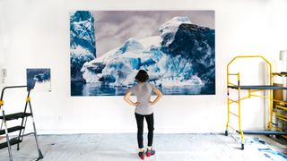 Zaria Forman in her studio looking at Whale Bay no. 4, a drawing now on display at the Harvard University Center for the Environment.