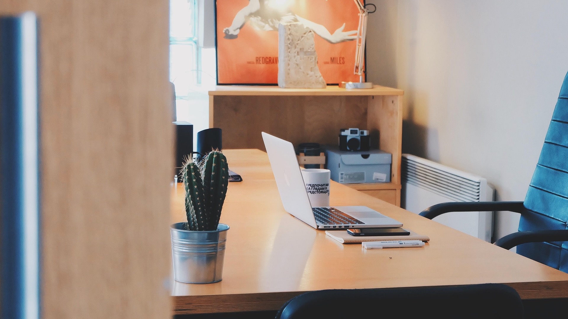 Traditional work desktop with a laptop on top,