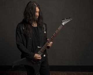 Rob Cavestany holds his Jackson signature guitar