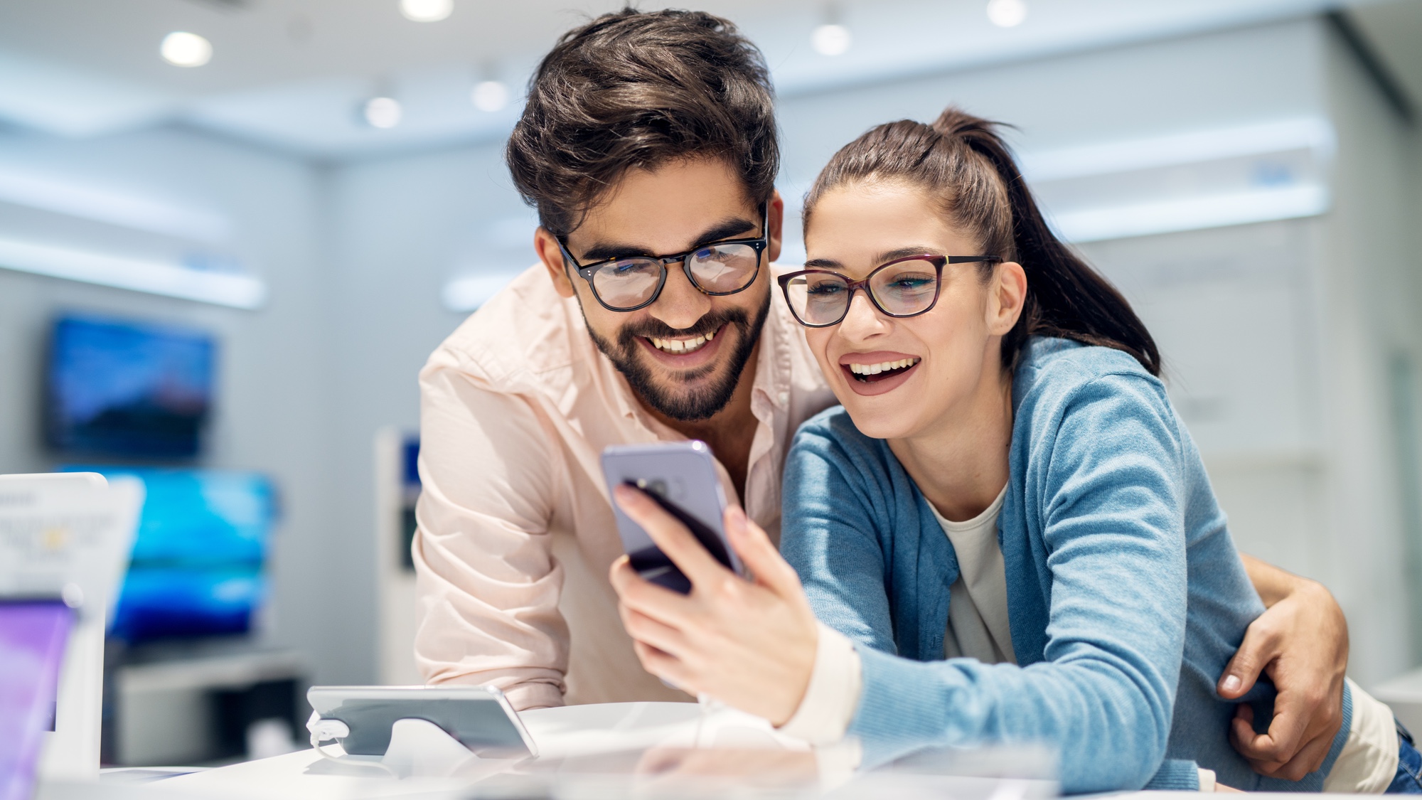Two people shopping for a phone