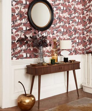 Wooden console table by John Lewis & Partners with gold cherry accessory and printed wallpaper