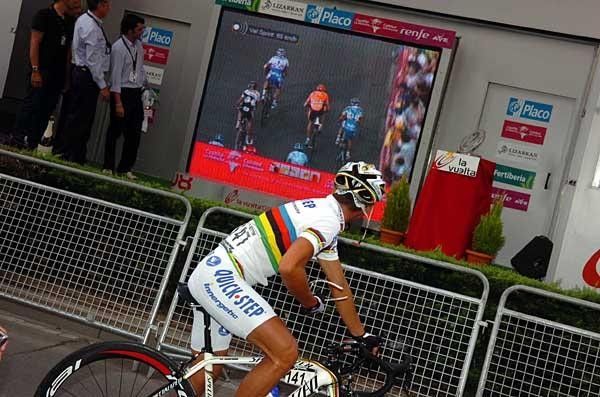 Paolo Bettini watches the replay of his teammate's win.