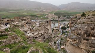 An view from up high showing an ancient city set into a hillside