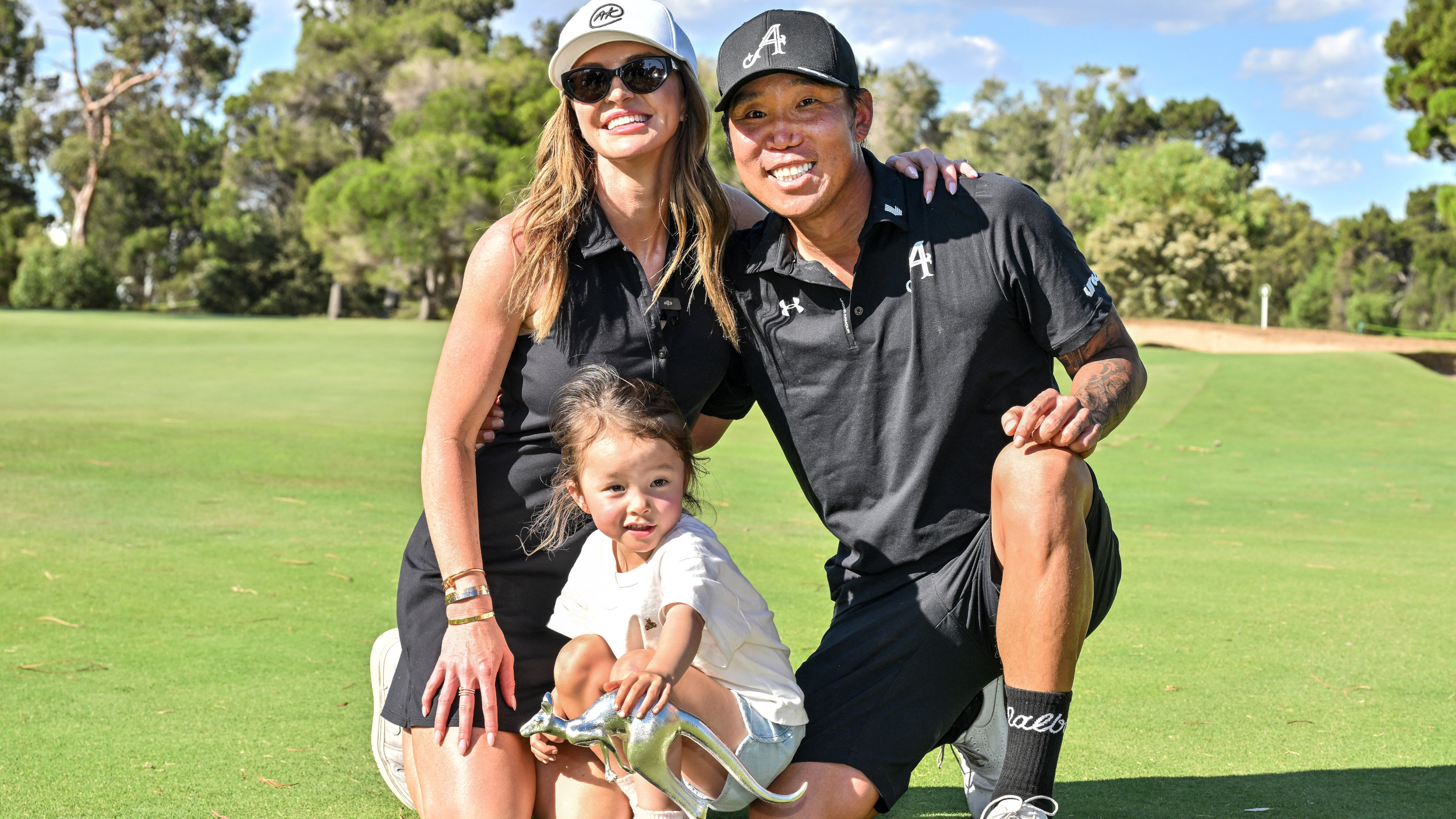 Anthony Kim with his wife and daughter celebrating his win at LIV Golf Adelaide.