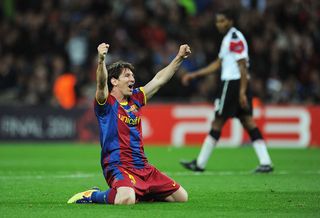 Lionel Messi of FC Barcelona celebrates as David Villa scores the third goal during the UEFA Champions League final between FC Barcelona and Manchester United FC at Wembley Stadium on May 28, 2011 in London, England.