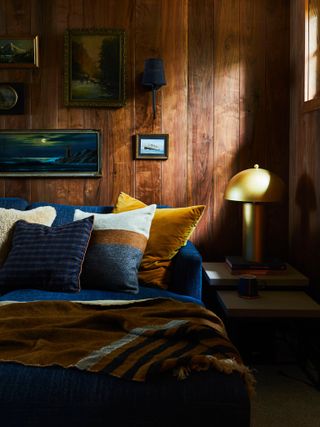 Wood panelled bedroom with blue bed