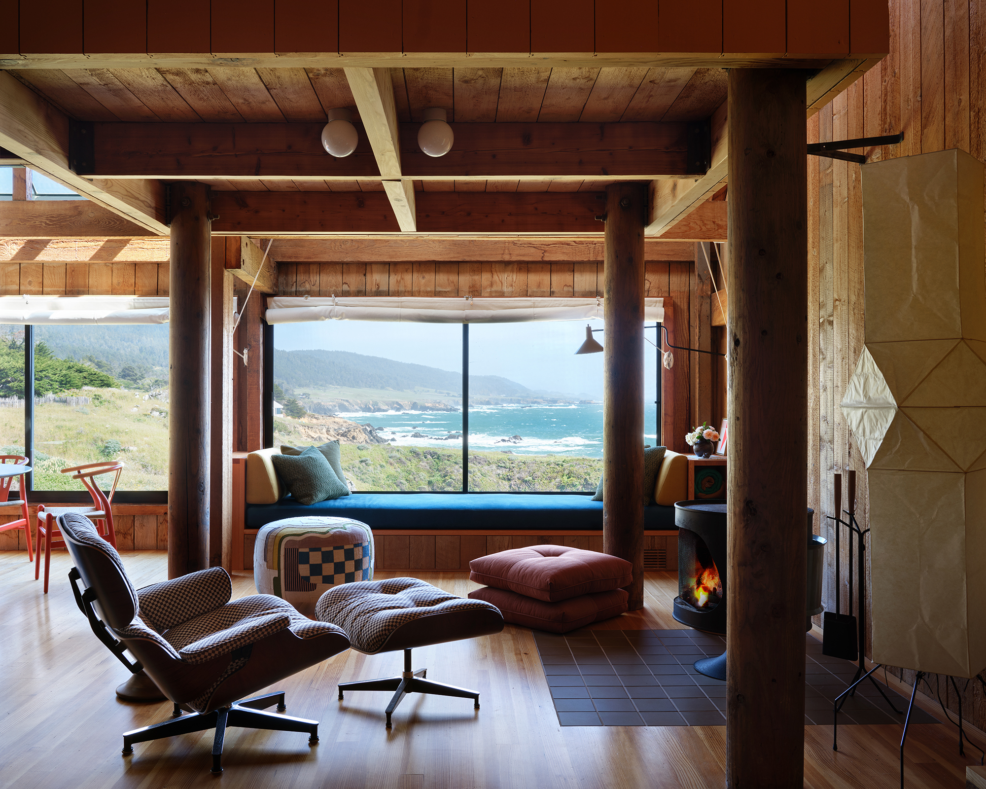 living room with mid century furniture and view of a beach out the window