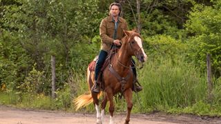 Jack riding Sugar the horse down a country lane in Virgin River season 6