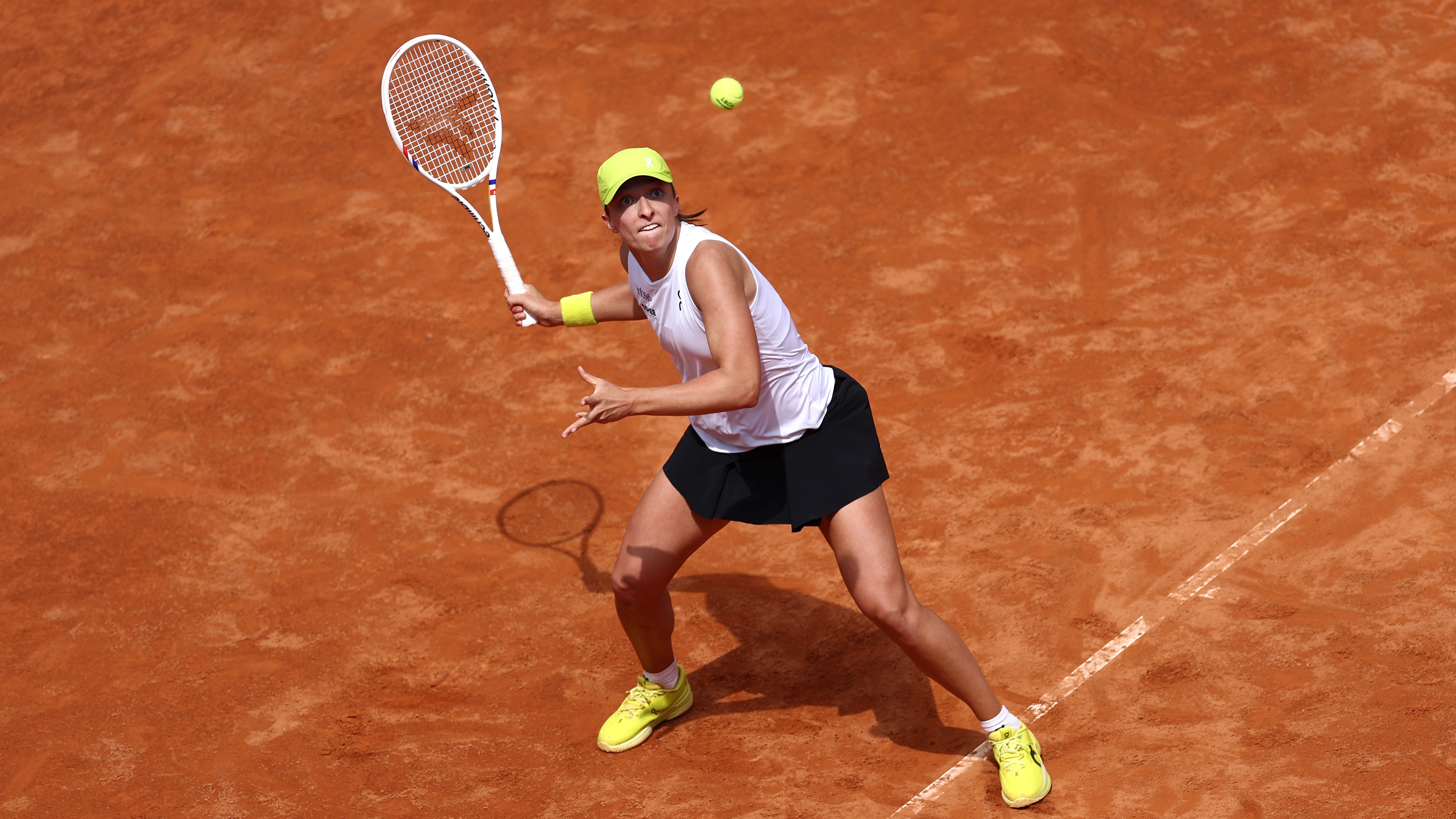 Iga Swiatek plays a shot in the French Open 2025