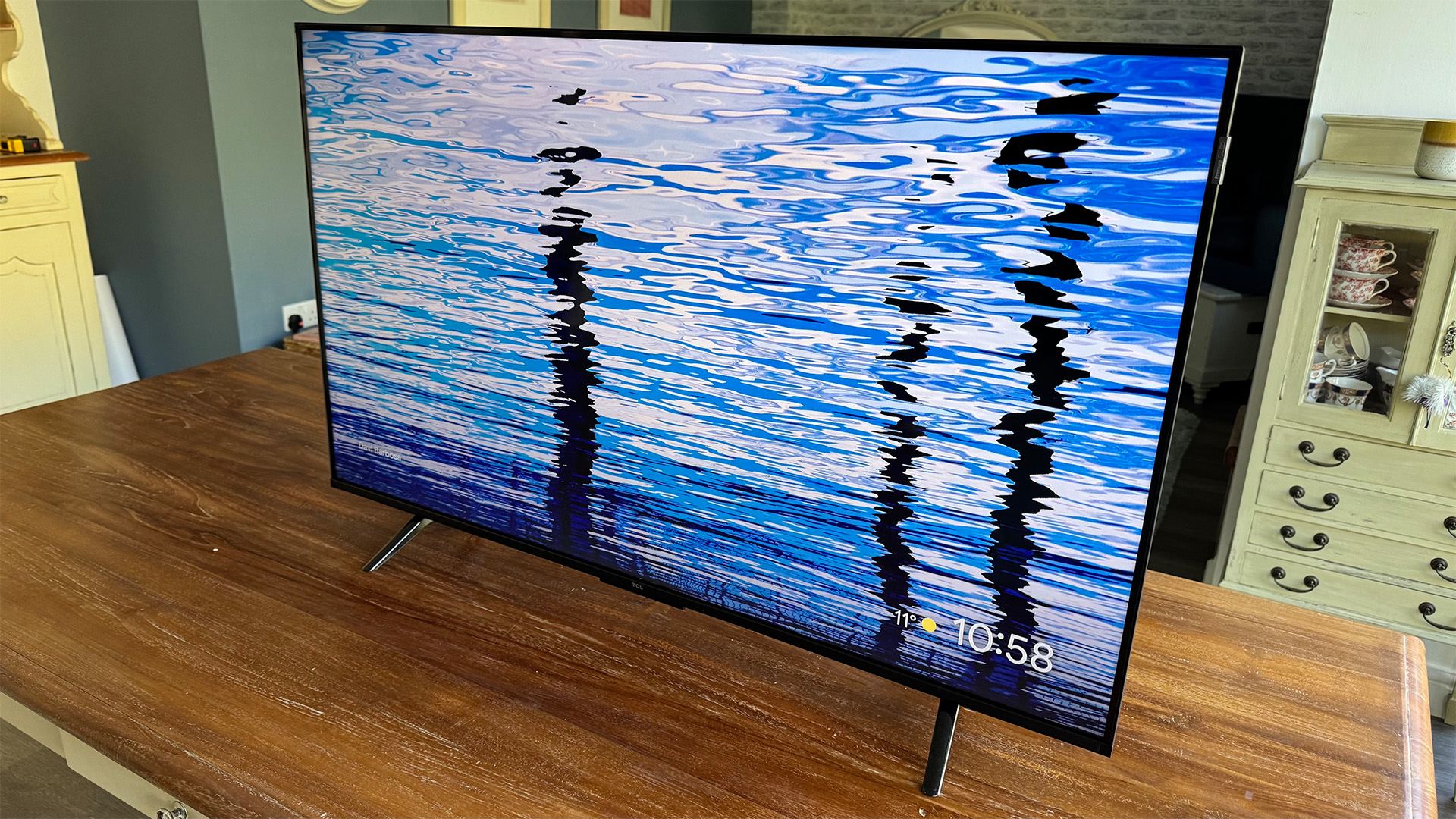 TCL P7K 43-inch TV on wooden table, on screen is reflective water
