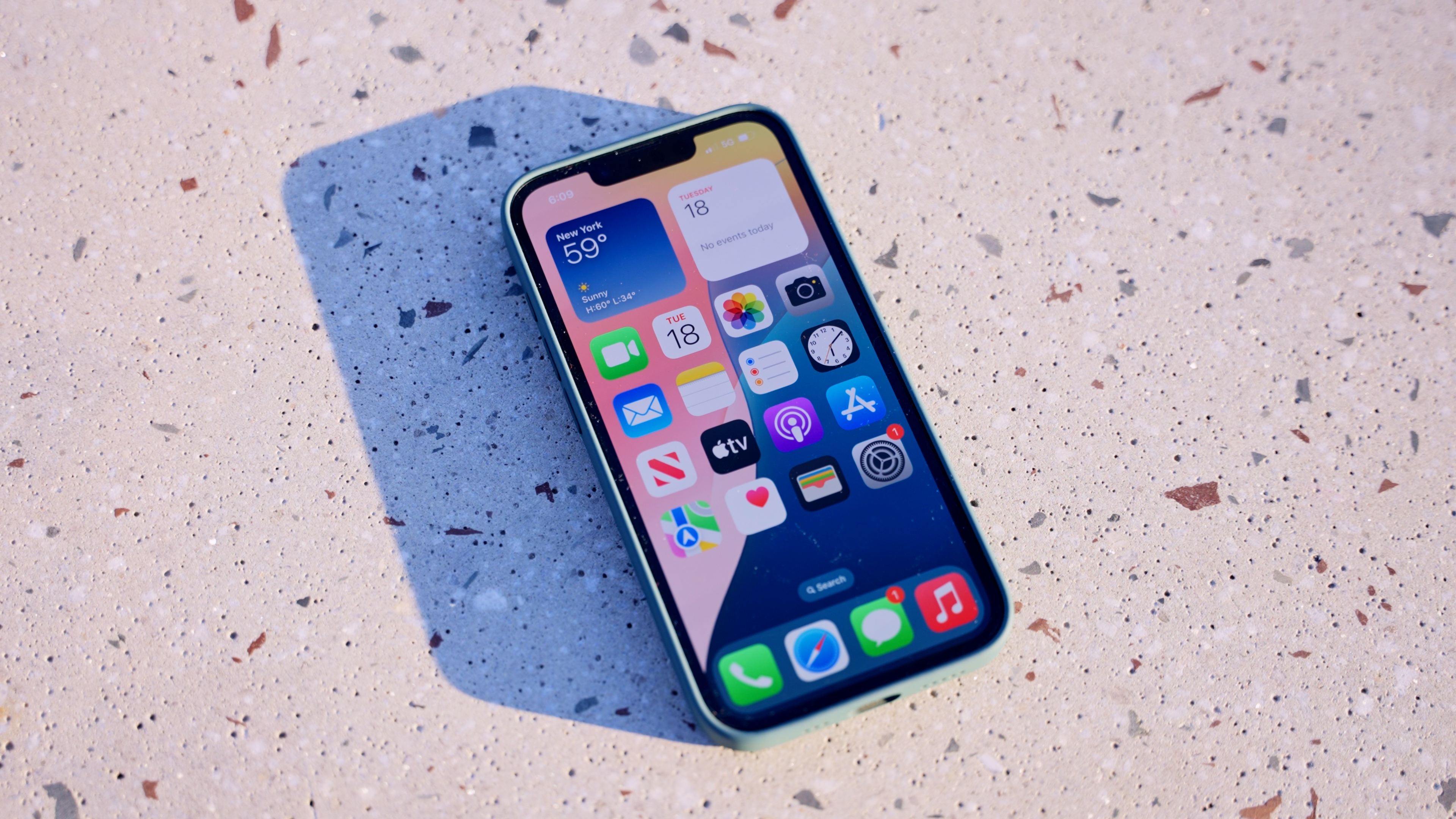 iPhone 16e laying flat outdoors
