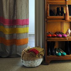 multicolour curtain with wooden basket and wooden cabinet