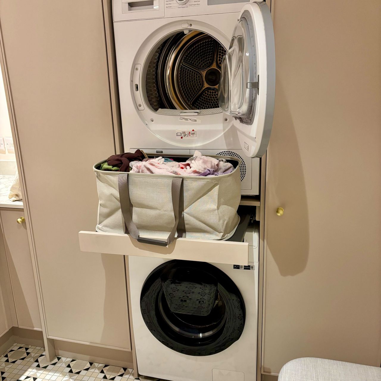 utility room with washing machine and dryer with a Joseph Joseph collapsible basket