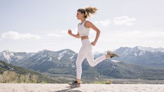 Young woman running in mountainous setting