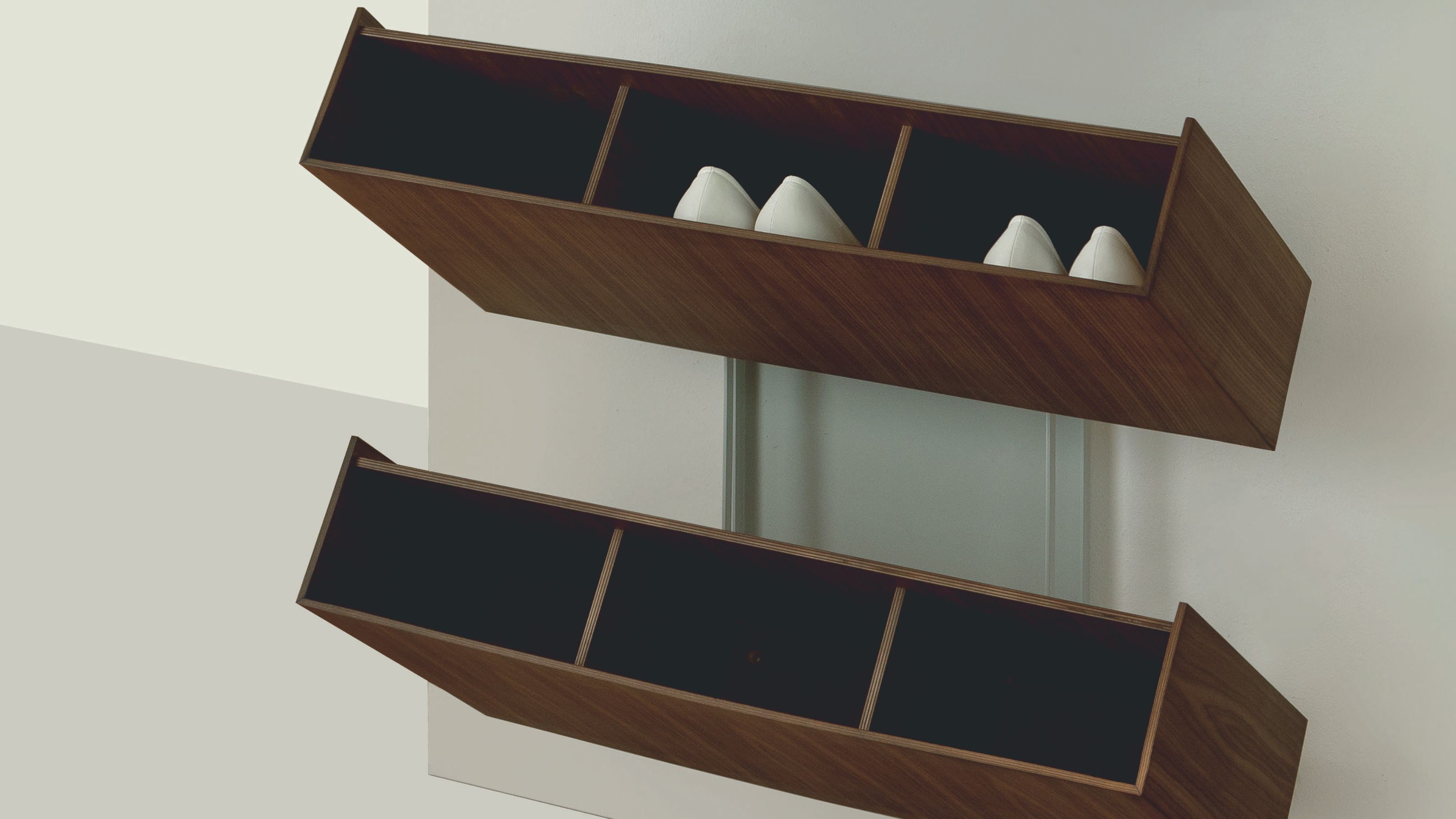 A tilting shoe rack with shoes inside of it 