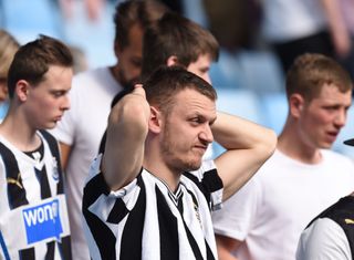 Newcastle United fans look dejected ahead of their team's relegation during a game against Aston Villa at Villa Park in May 2016.
