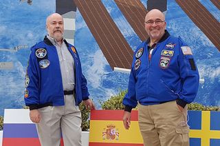 Space mission patch artists Jorge Cartes of Spain (at left) and Tim Gagnon of Florida pose together at NASA's Kennedy Space Center Visitor Complex in Florida in 2016.