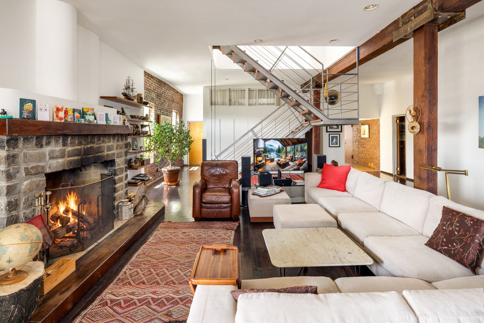 Details of the penthouse at 719 Greenwich Street, showing a characterful home with lots of wood, exposed brick, and fabulous views