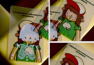 Plastic business cards show skeleton cartoon one side and clothed character on the other