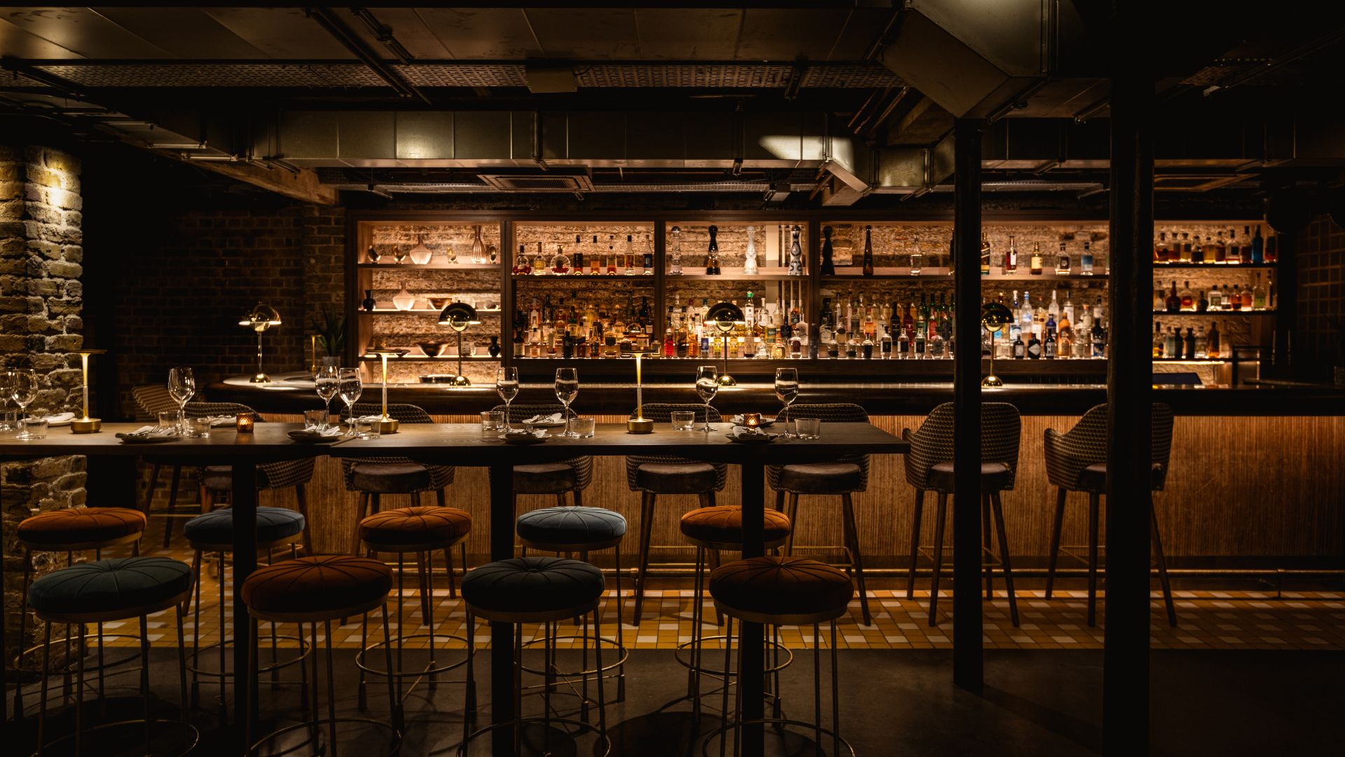 an image of the bar and central high table with stools around it at downstairs at sucre