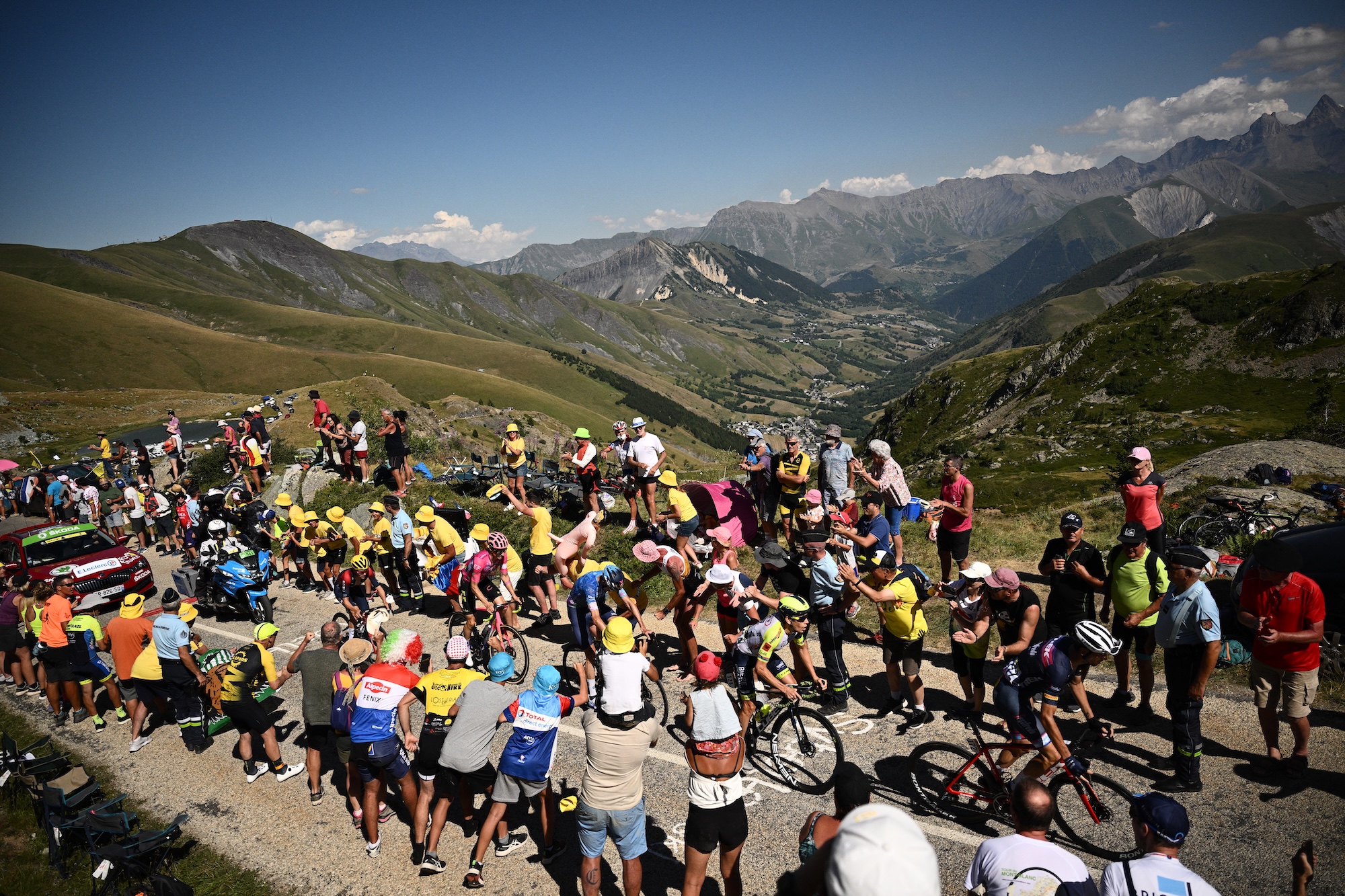 Breakaway riders cycle in the ascent of Alpe d'Huez during the 12th stage of the 109th edition of the Tour de France cycling race, 165,1 km between Briancon and L'Alpe-d'Huez, in the French Alps, on July 14, 2022. (Photo by Marco BERTORELLO / AFP)