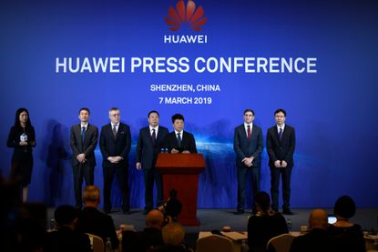 Huawei's rotating chairman Guo Ping (C) speaks during a press conference in Shenzhen, China's Guangdong province on March 7, 2019.