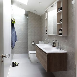 bathroom with grey metro tiles and basin