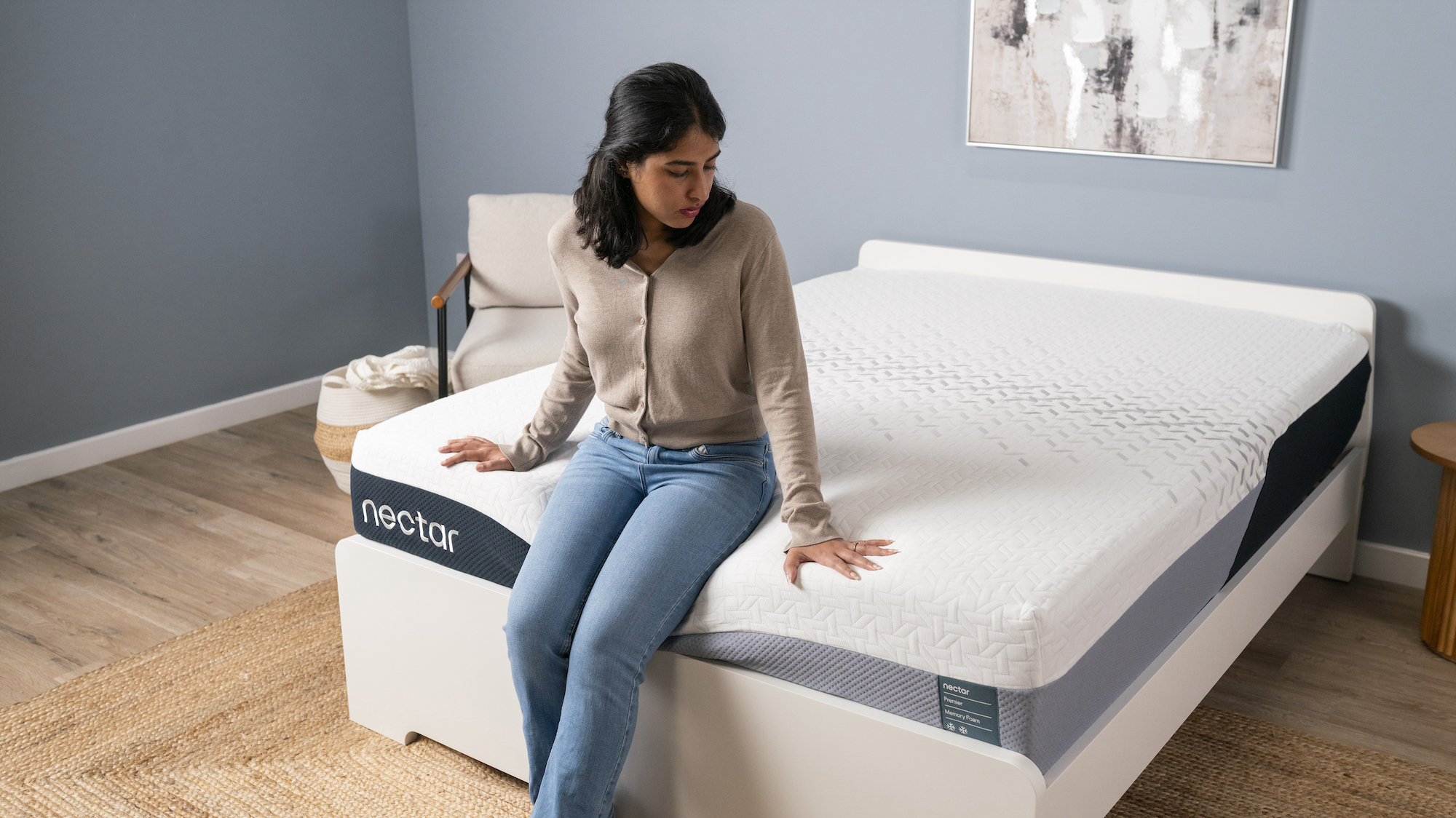 Our Sleep Staff Writer Becky George sits on the edge of the Nectar Premier Memory Foam Mattress while our Managing Editor of Sleep Claire Davies records notes on the edge support during Becky's sit test