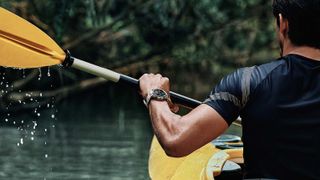 Man kayaking wearing Amazfit T-Rex Pro watch