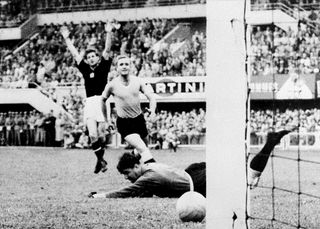 Hungarian forward Sandor Kocsis (left) celebrates as he scores against Uruguay at the 1954 World Cup.