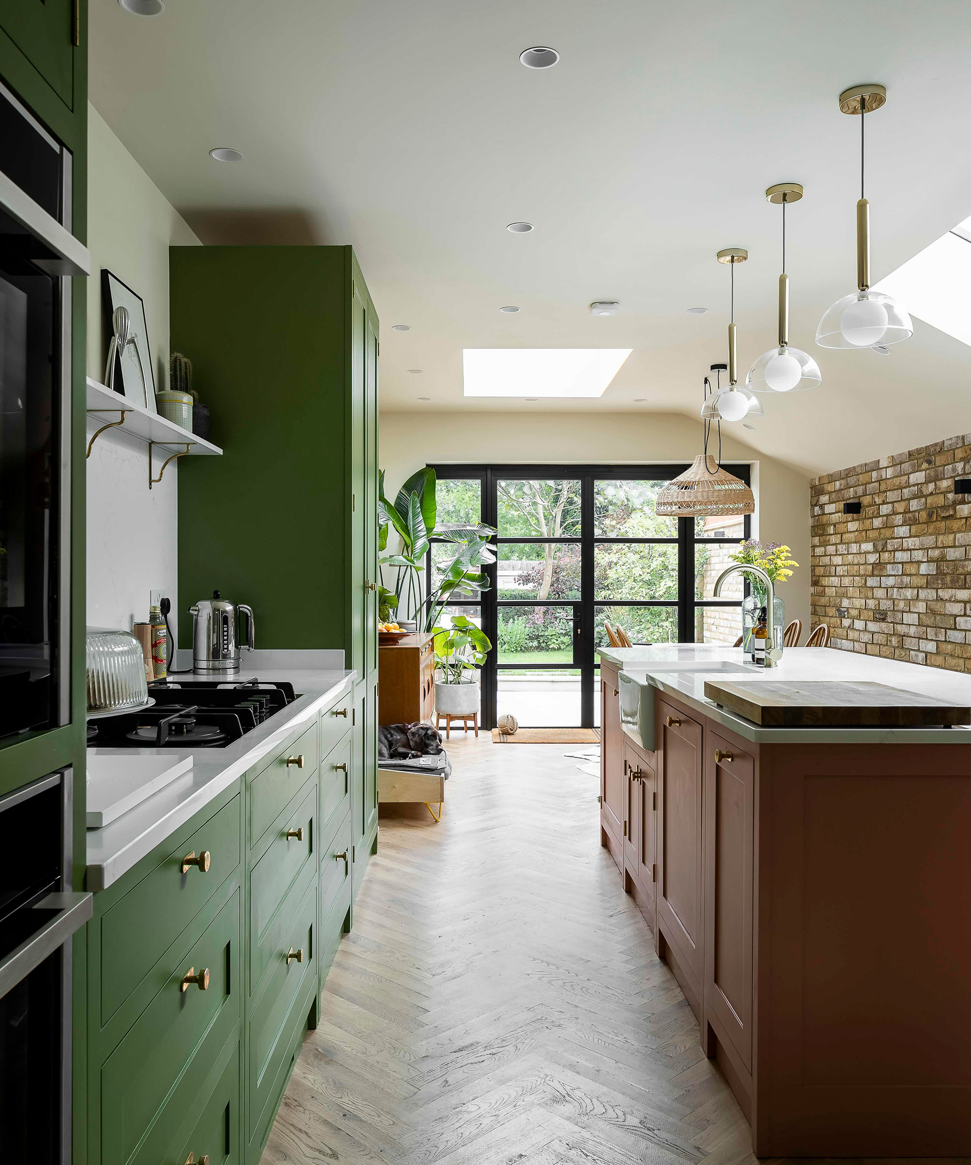 green Shaker kitchen with red kitchen island and herringbone flooring in galley kitchen layout