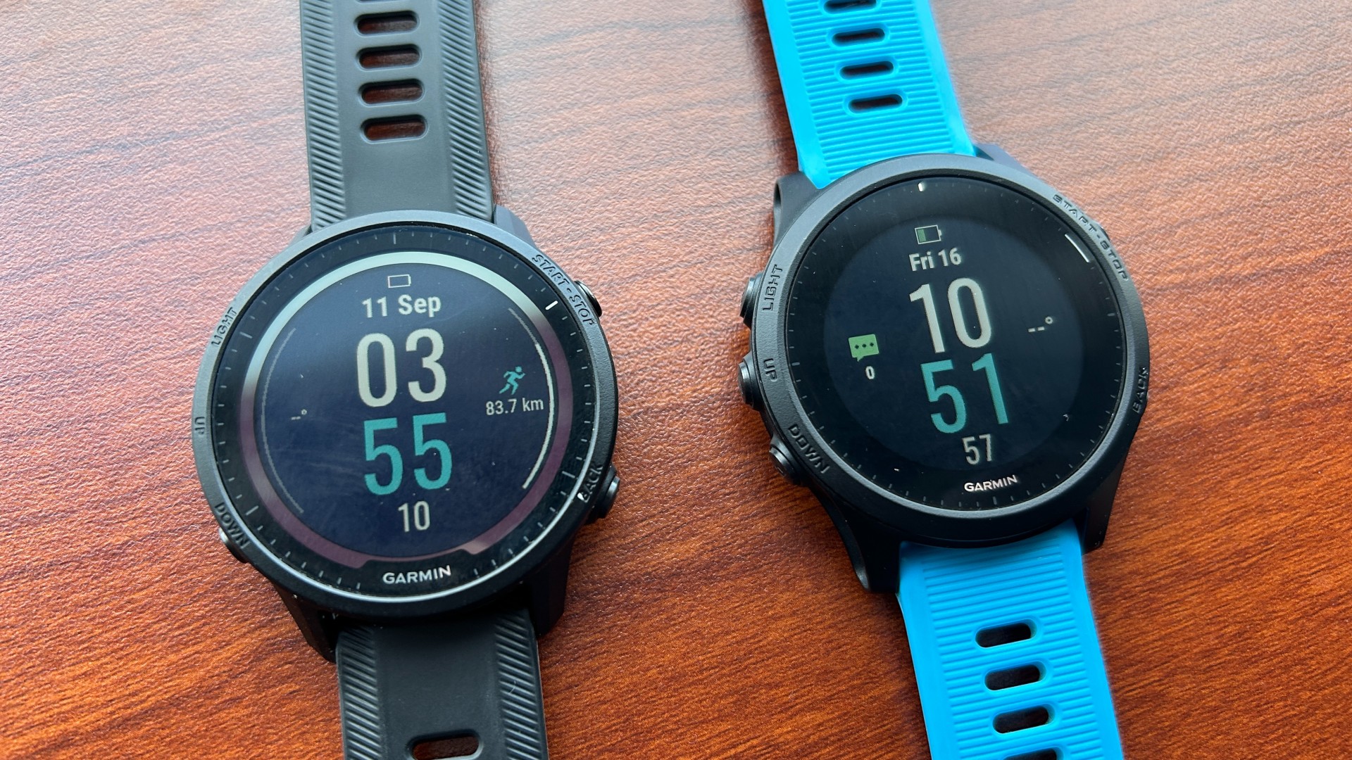 Garmin Forerunner 955 on left-hand side next to Garmin Forerunner 945