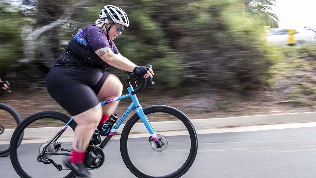 Marley Blonsky riding her bike on the road