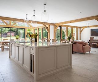 inside of oak frame extension showing kitchen island, sitting area and dining space