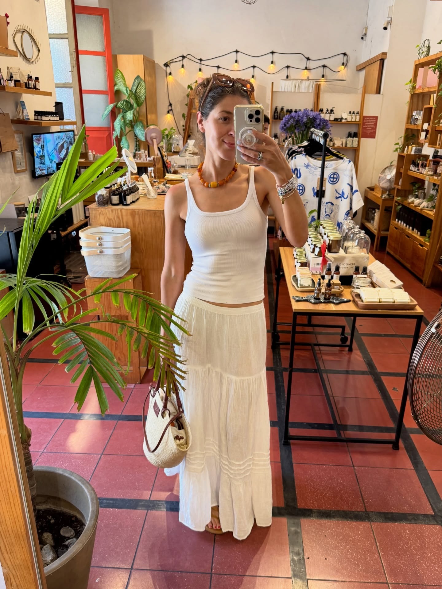 Judith Jones in a white tank top and white flowy skirt