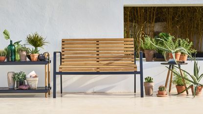 A modern wooden garden bench in a contemporary outdoor space