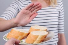 A person turns down some bread that is offered.