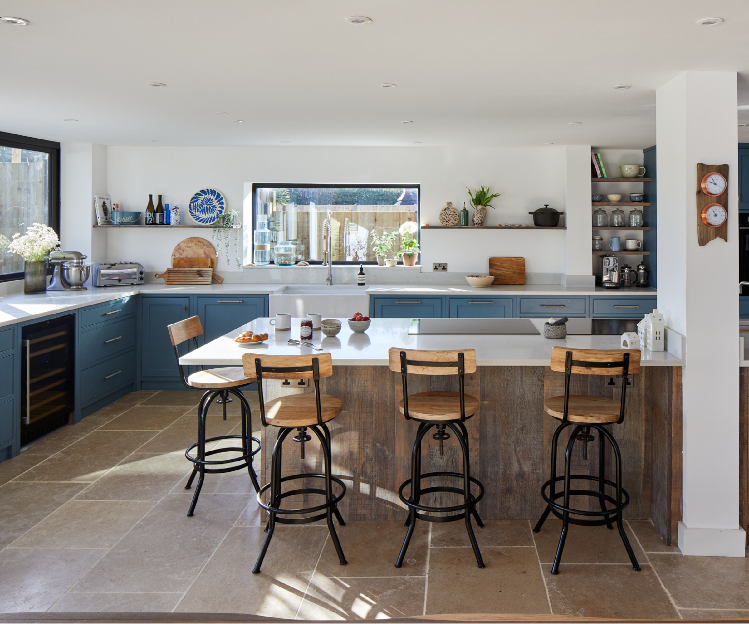 kitchen with island and small white spots placed around kitchen ceiling