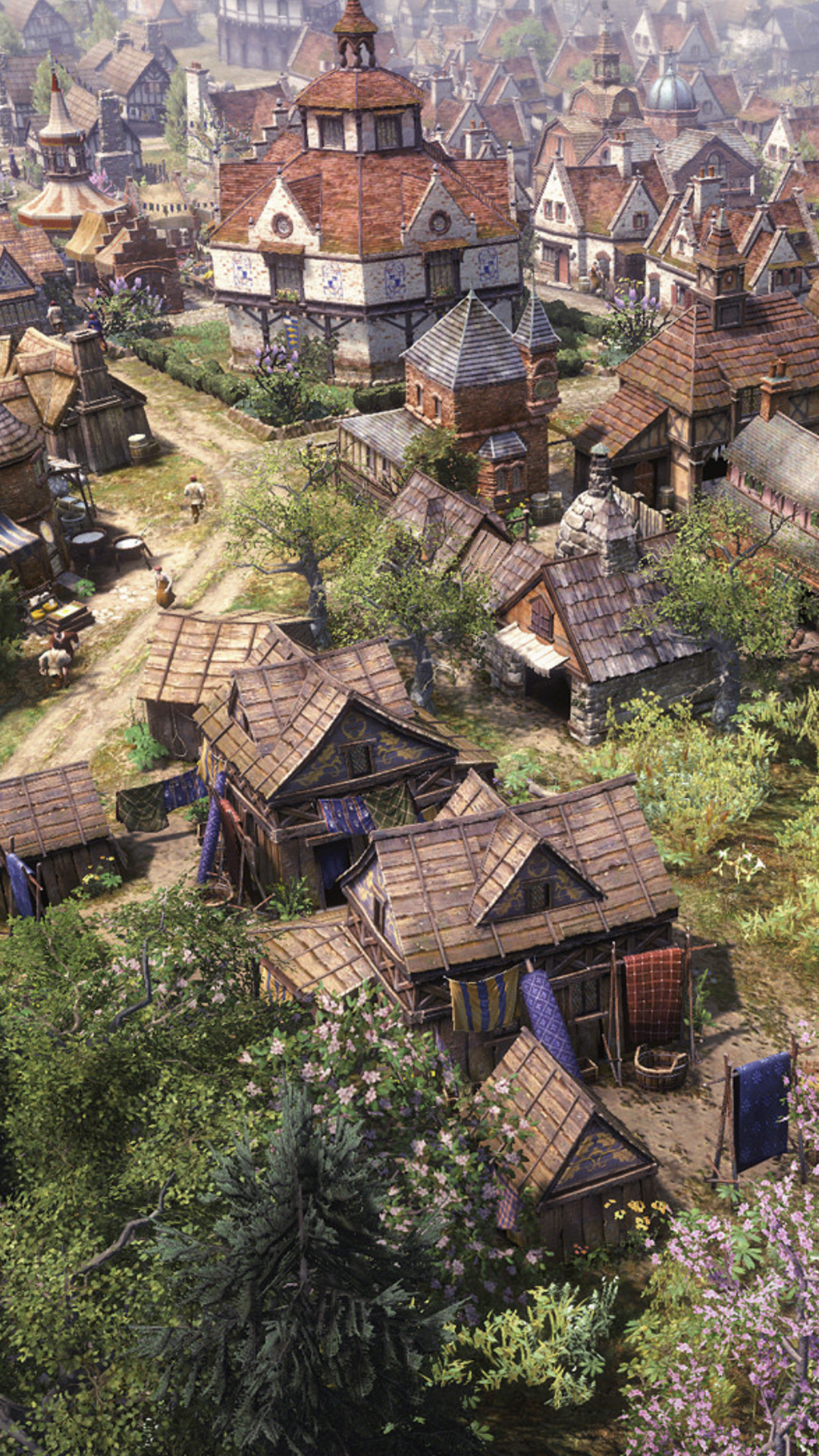 A growing village in Farthest Frontier filled with old wooden shacks and a few taller brick buildings