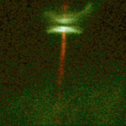 A streak of red is seen crossing two flat white and green disks against a dark green background