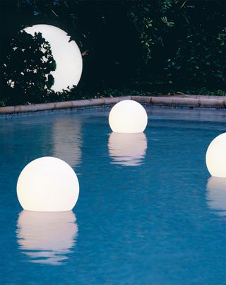 floating light orbs in a pool