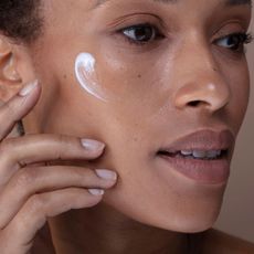 woman using one of the best eye creams for wrinkles - getty images 1426828652